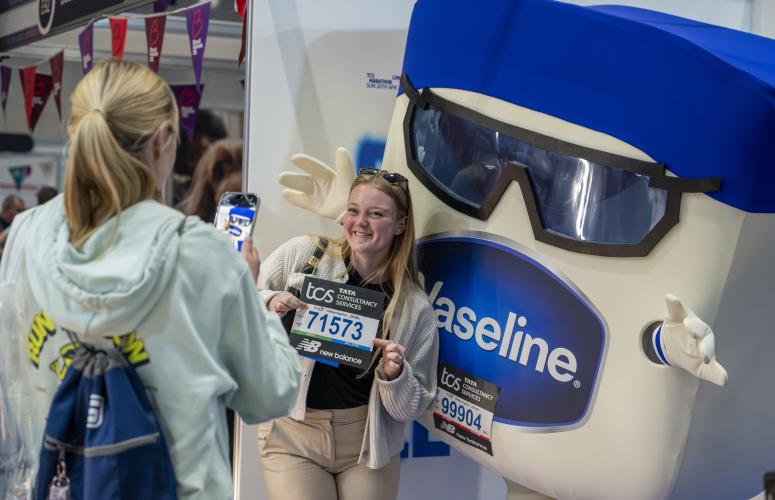 Runners posing with a Vaseline mascot 