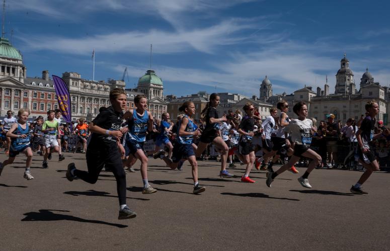 A group of participants running along the course