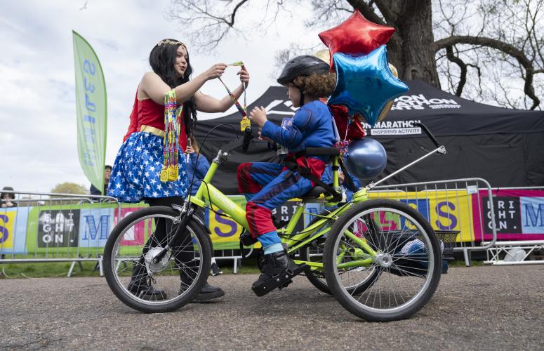 A child receives their medal at the Finish Line