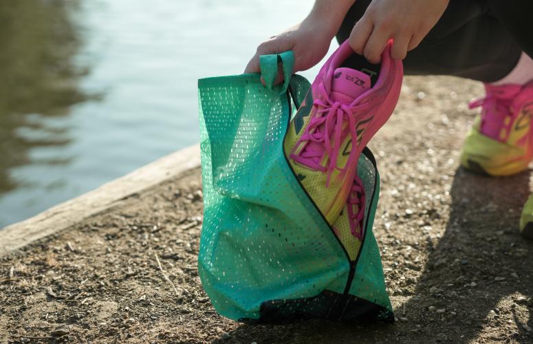 Runner showing off on of the Big Half shoe bags