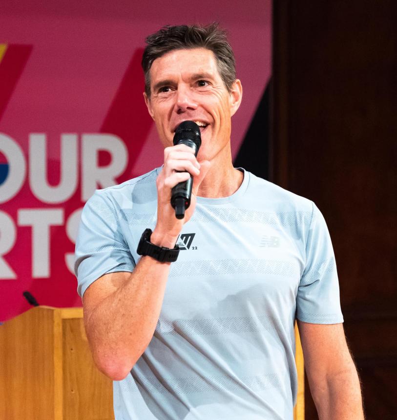 Martin Yelling on stage speaking with a microphone in hand