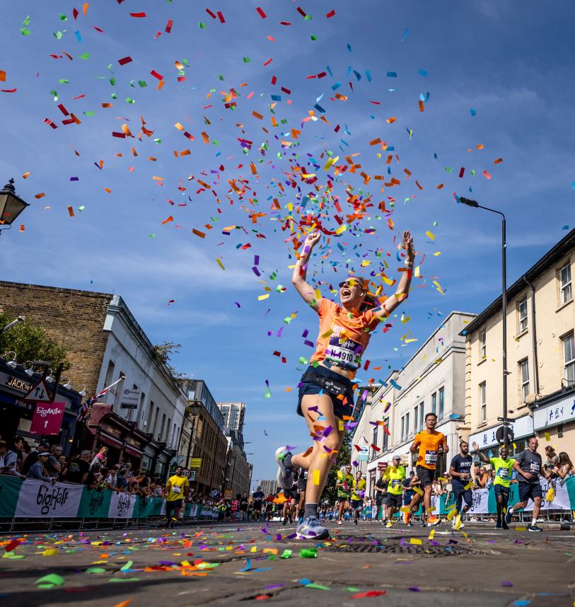 Big Half participant celebrates finishing the event in a cloud of confetti