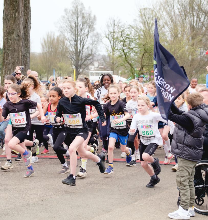Children running at the start line of the Brighton mile race.
