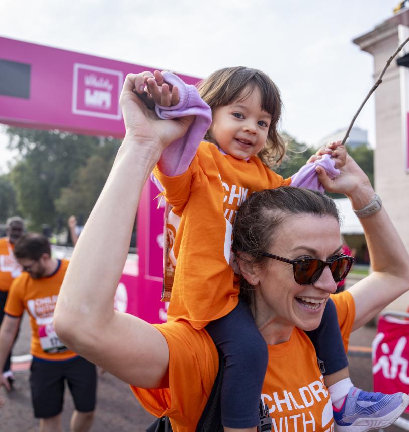 Toddler on shoulders of mum