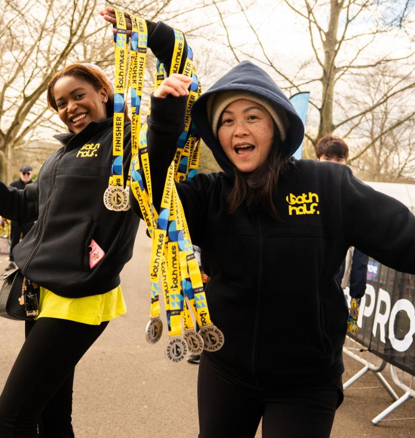 Bath Miles volunteers handing out medals at the Finish Line