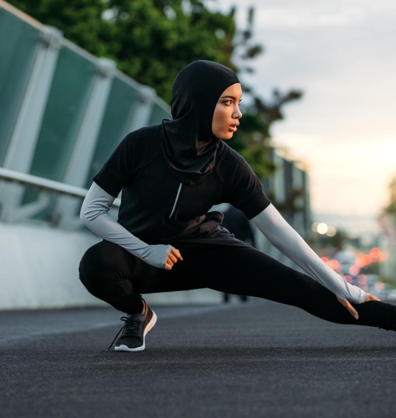 Woman stretching on a bridge before exercising