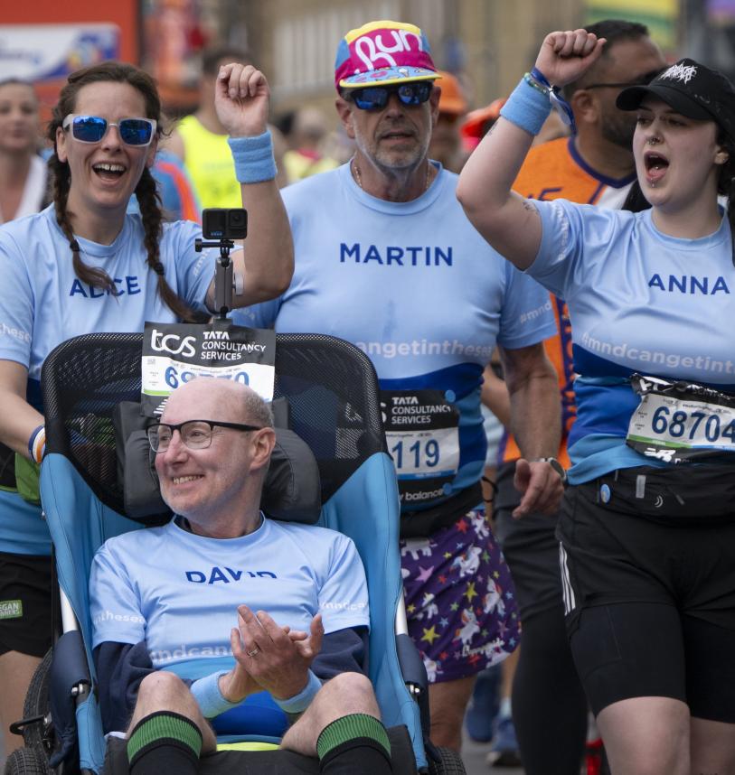 Assisted wheelchair group on the course