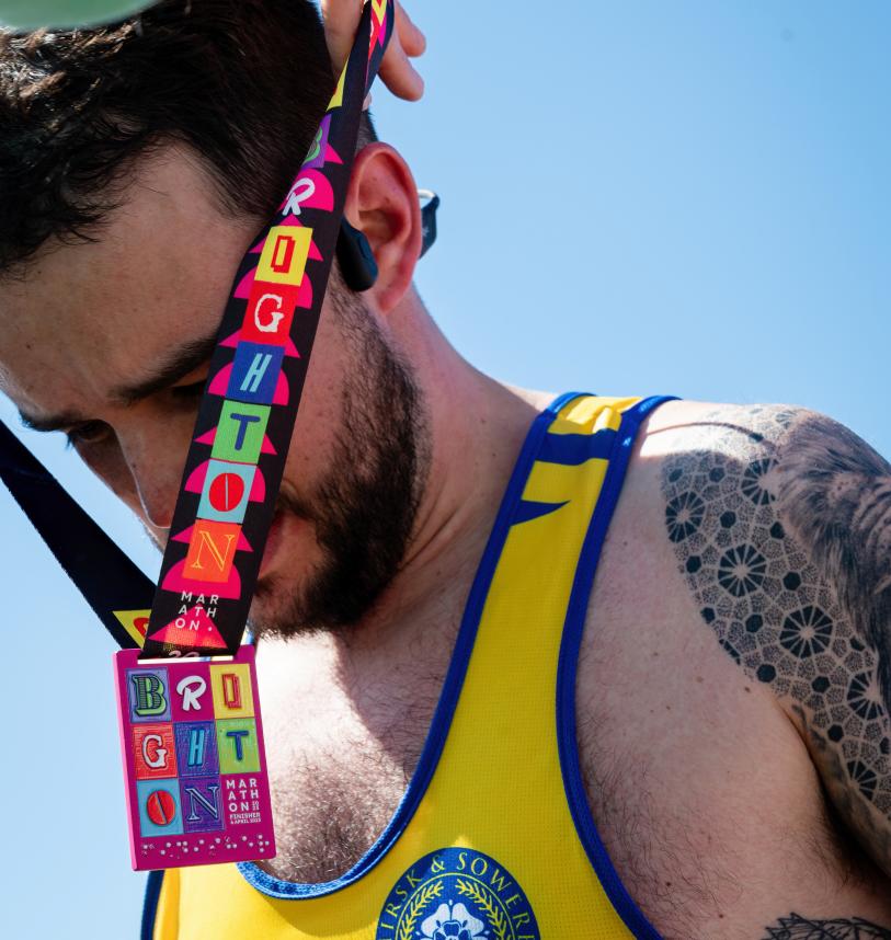 Volunteer putting a medal on a participant