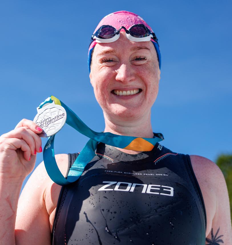 Swim Serpentine participant with their medal at the Finish