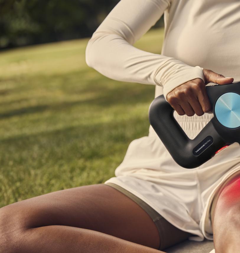 Runner using a Theragun