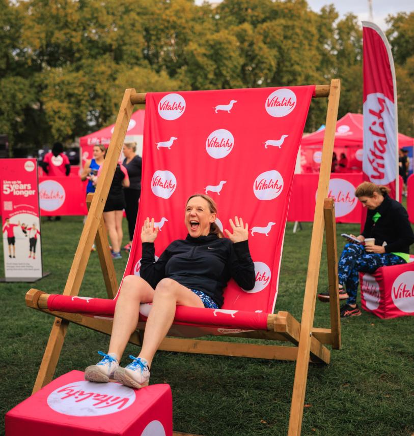 Runner poses in a giant deck chair at the Wellness festival