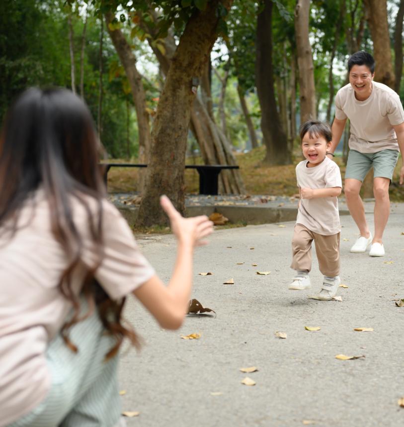 Son running towards his mother in the park