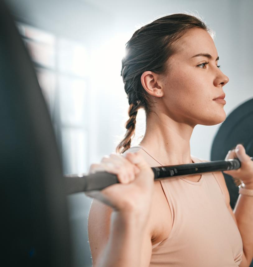 Woman holding a barbell in the front rack position 