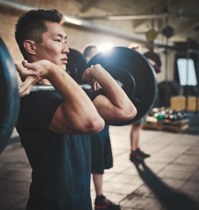 Man with a barbell in front rack