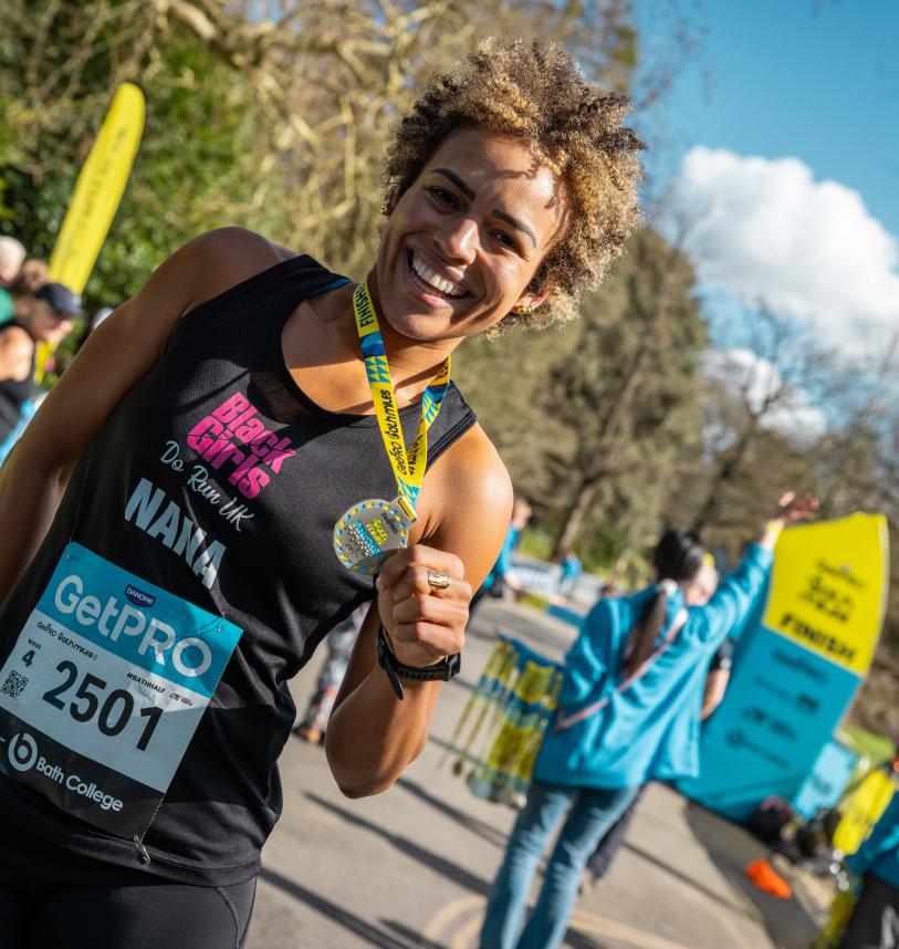 A Bath Miles participant celebrates with their medal