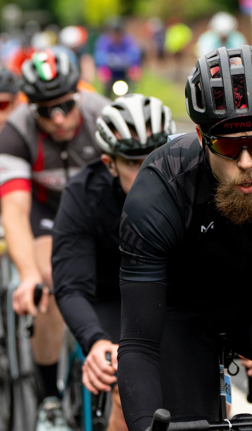 Line of cyclists cycle down road during RideLondon