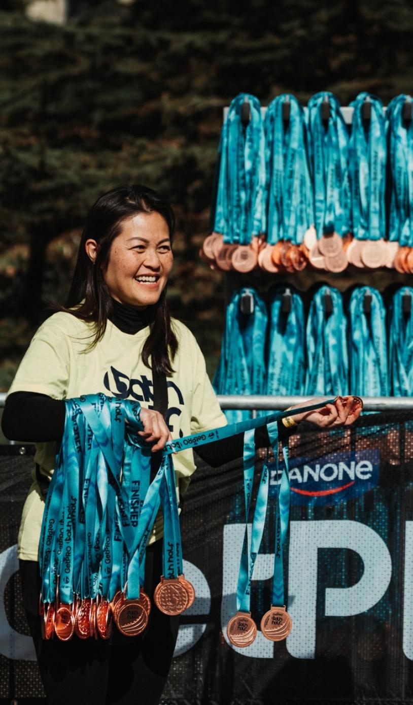 GetPRO Bath Half volunteer handing out medals