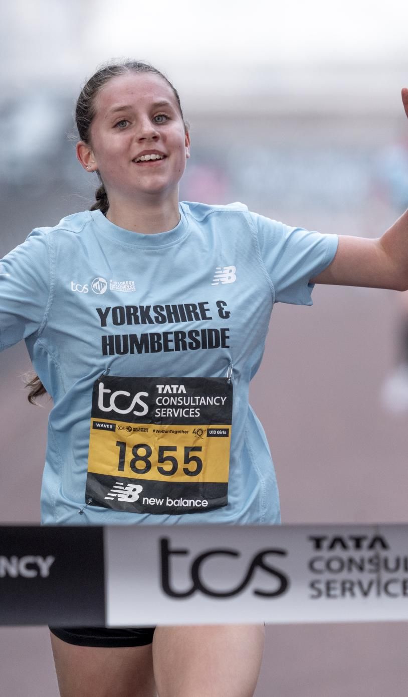 Jessica Thake celebrates as she crosses the finish line to win the U13 Girls race during the TCS Mini London Marathon Championships 