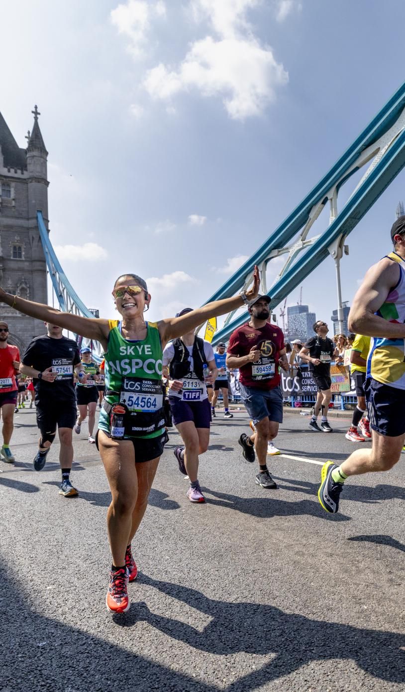 Participants running across Tower Bridge