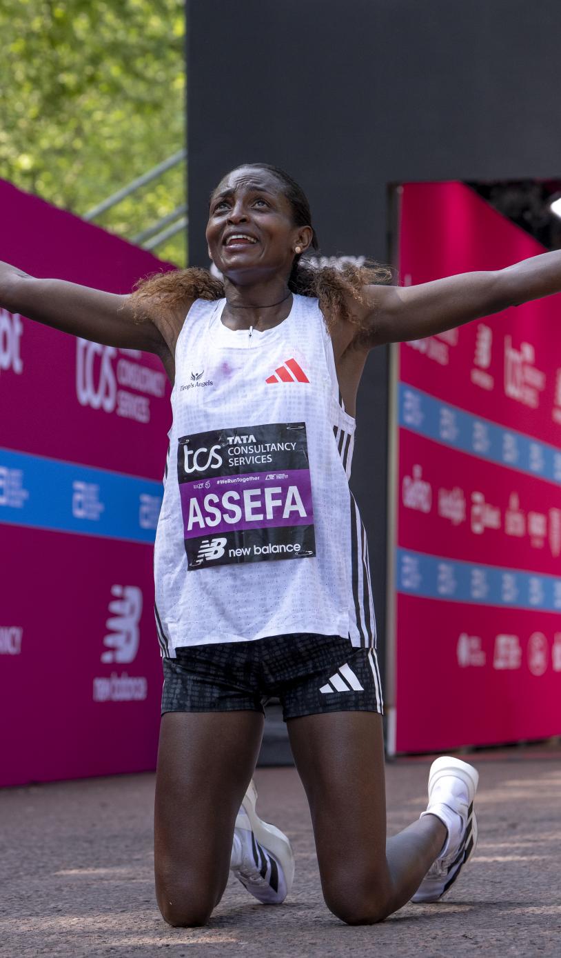 Tigst Assefa reacts as she crosses the Finish Line