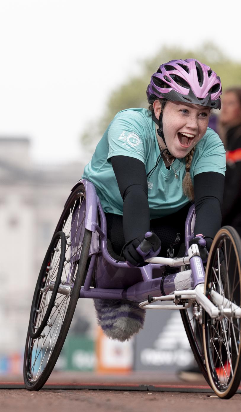 Niamh Currie, U17 Women Wheelchair winner, crosses the Finish Line