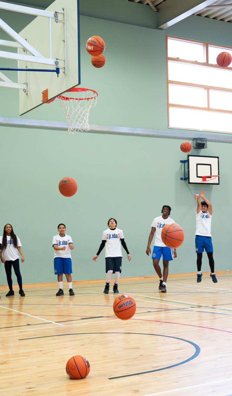 Young people shooting hoops for the Jr. NBA 3v3 launch
