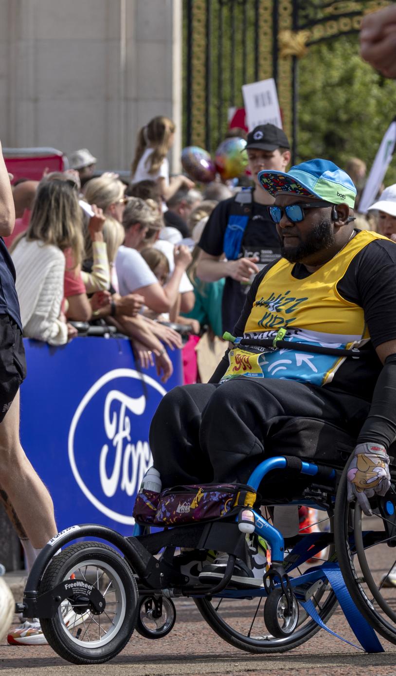 Participant in a wheelchair approaching the Finish Line