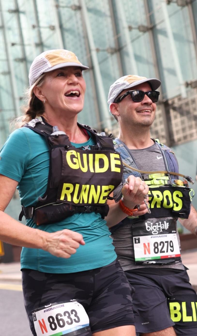 A blind runner and their guide at The Big Half