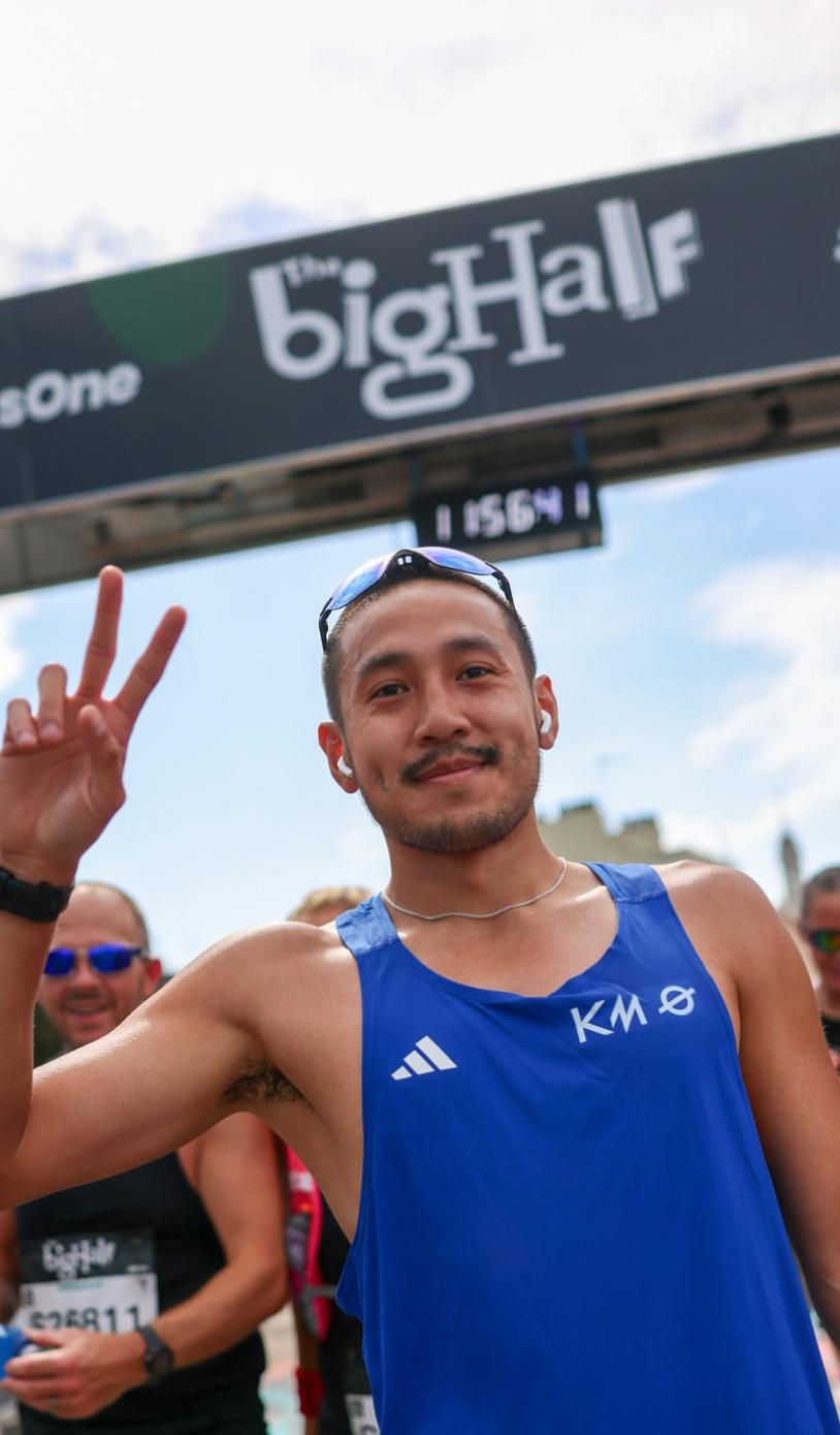 Participant throwing a peace sign at the Finish Line