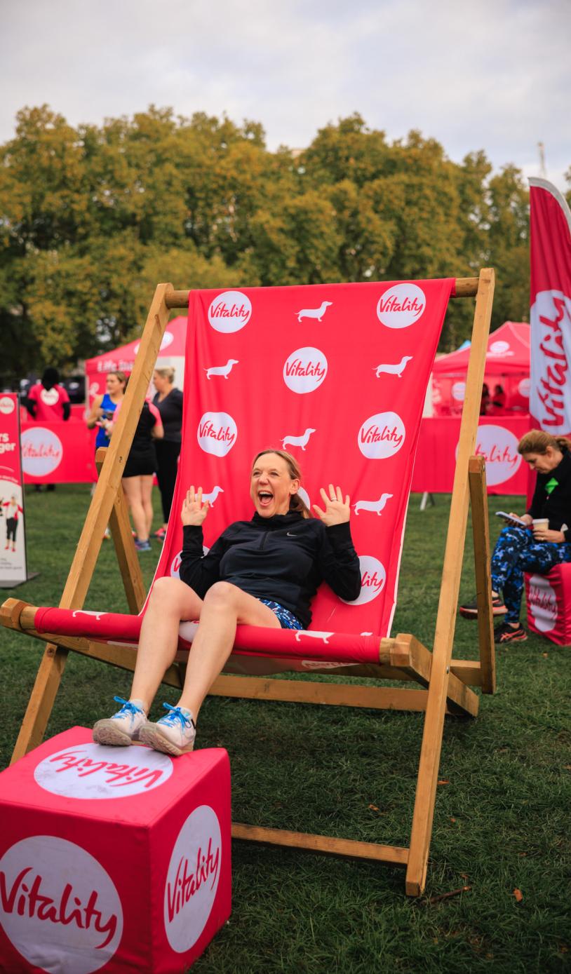 Runner poses in a giant deck chair at the Wellness festival