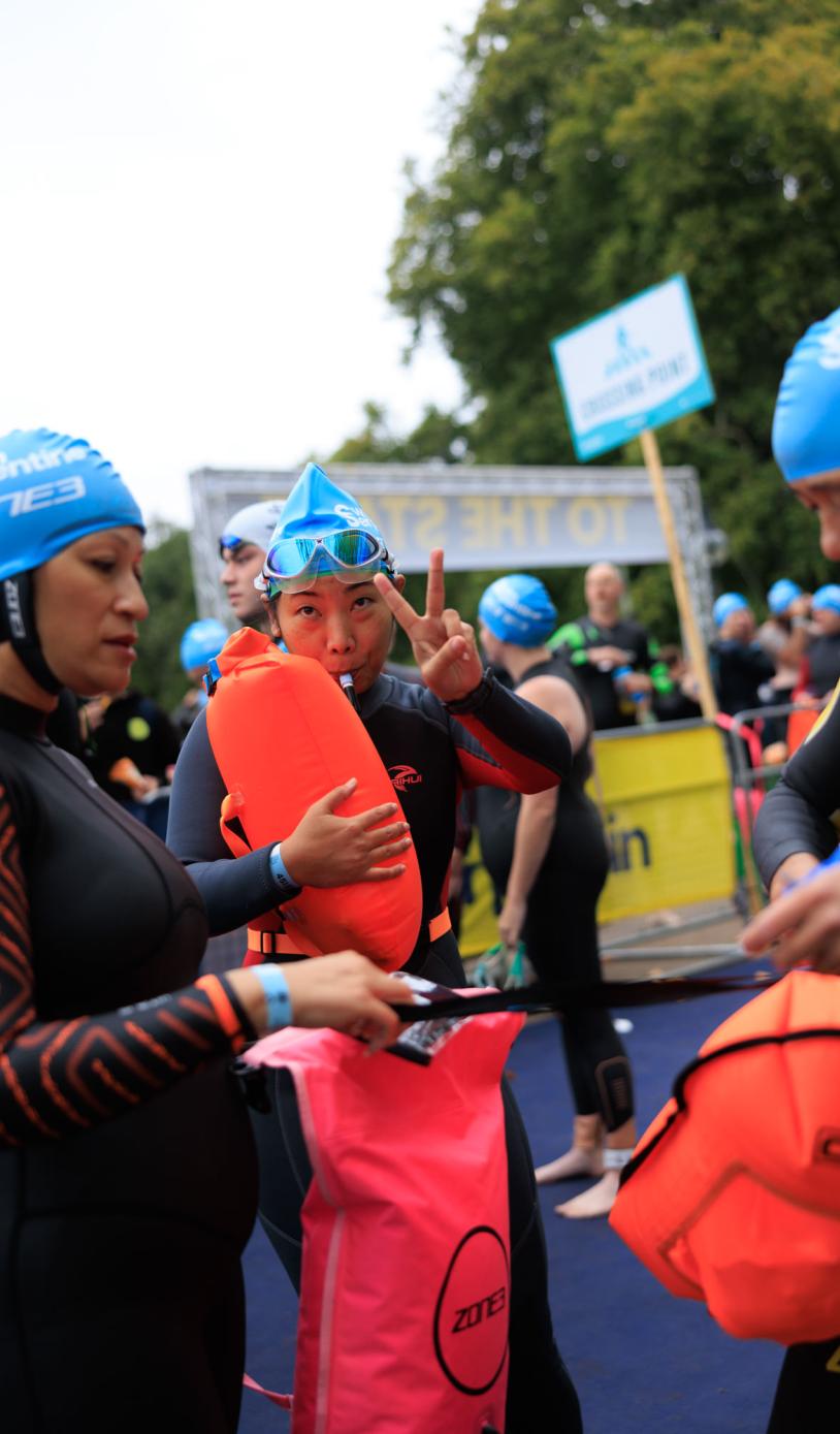 Swimmers blowing up their tow floats 