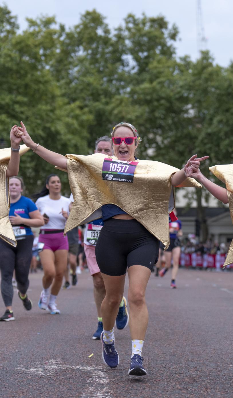 Participants dressed as starts approach the Finish Line