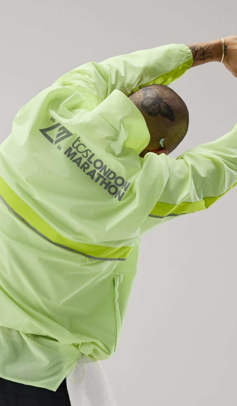 Man stretches in the TCS London Marathon New Balance Training tops