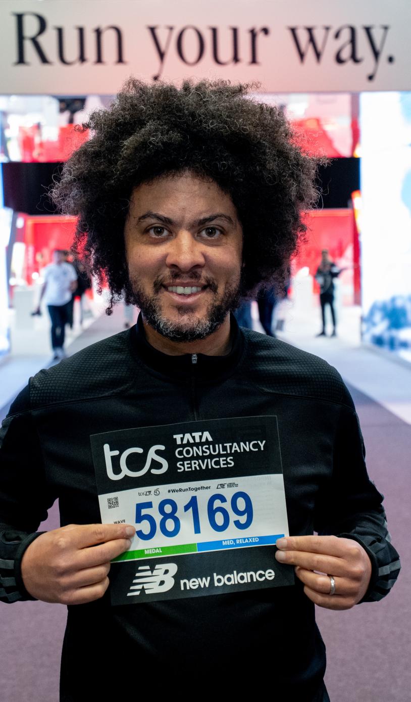 A runner collecting their number at the TCS London Marathon Running Show