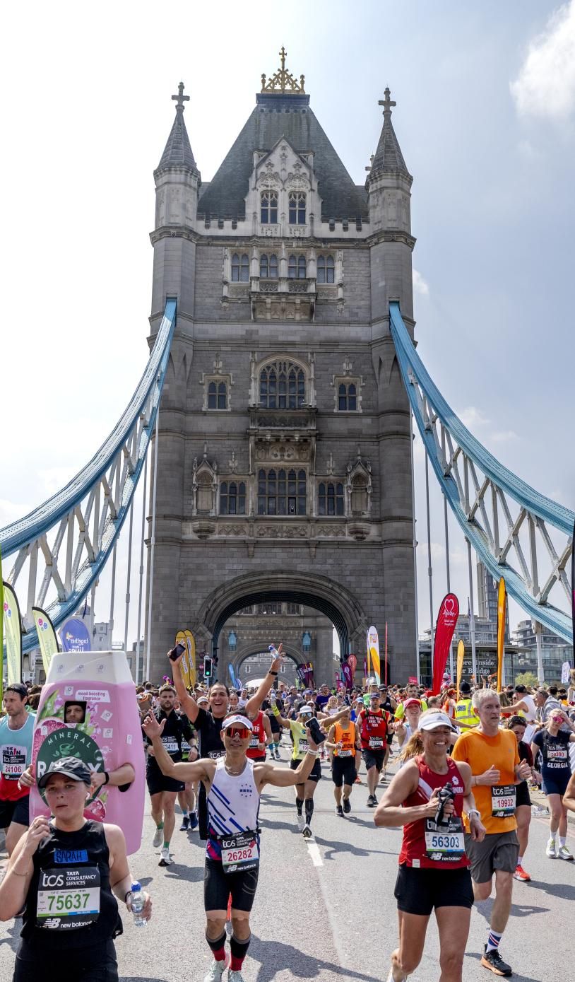 Participants running across Tower Bridge