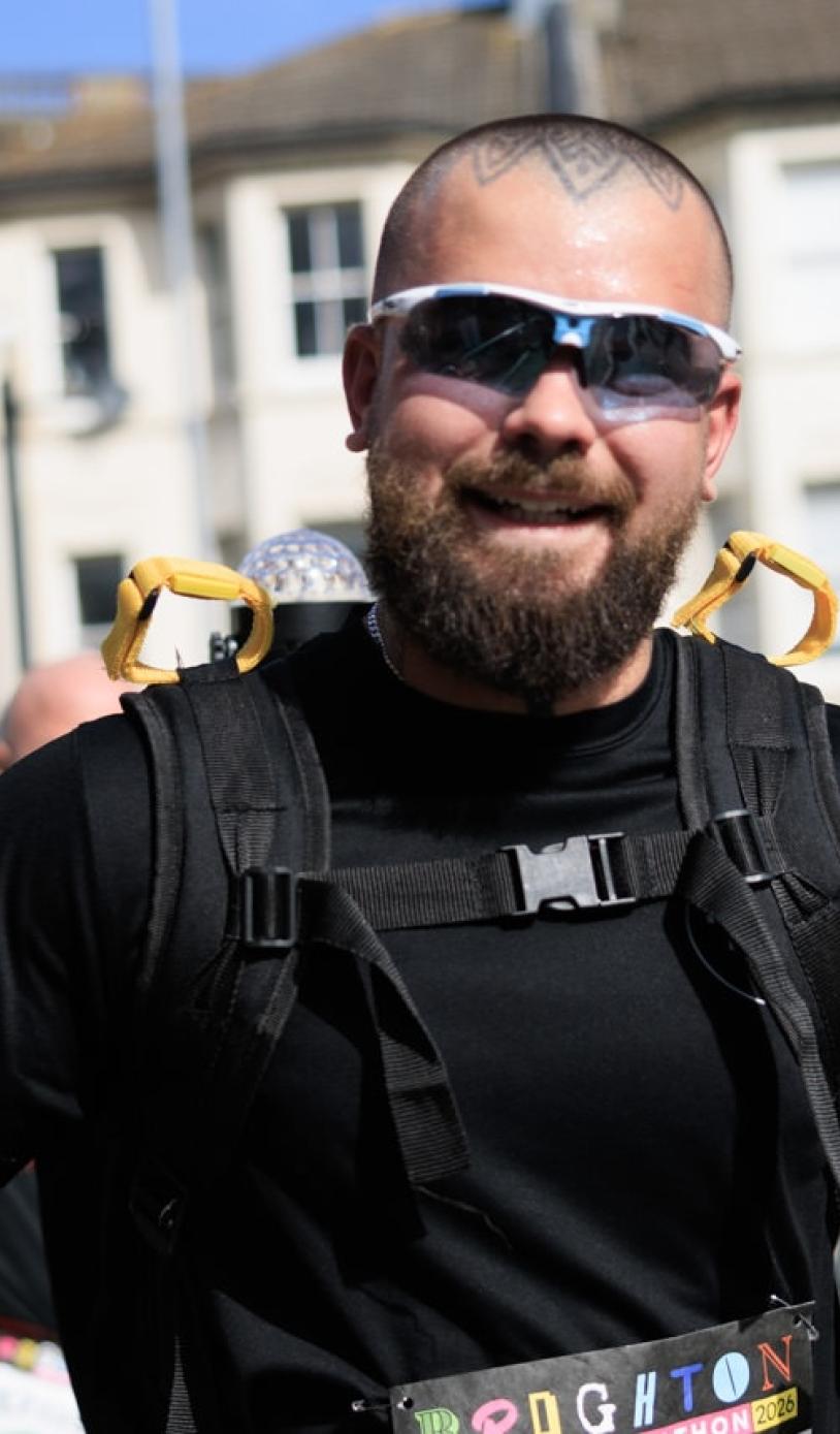 Man poses for the camera mid-run