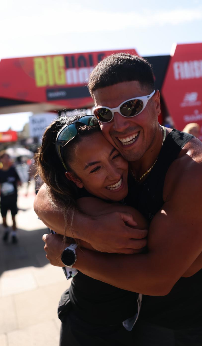 Two Big Half participants hug after crossing the Finish Line