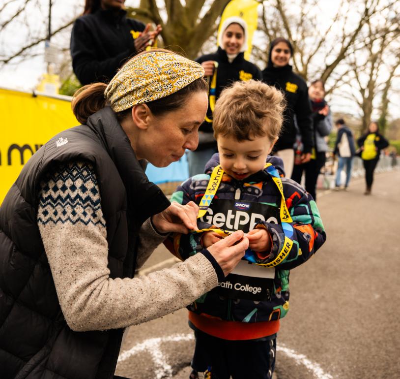 Bath Miles finishers looking at their medal