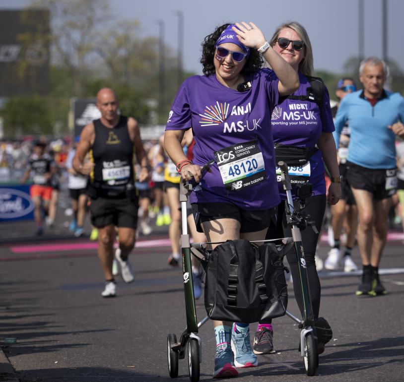 A participant using a frame walker leaves the Start Area 