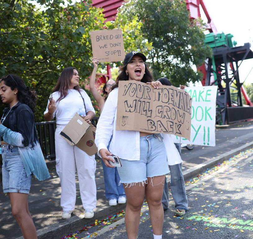 A group of supporters at the side of the road cheering