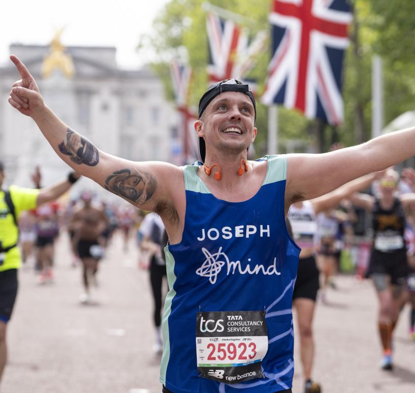 A runner celebrates at they head towards the Finish Line