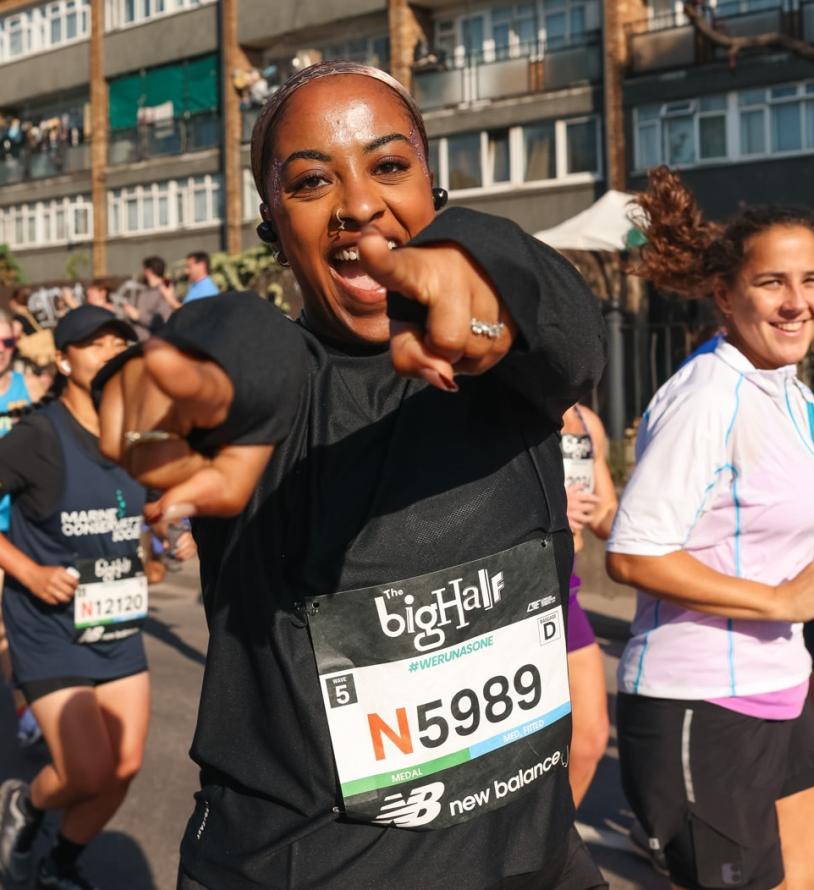 Woman celebrates as she runs the Big Half 