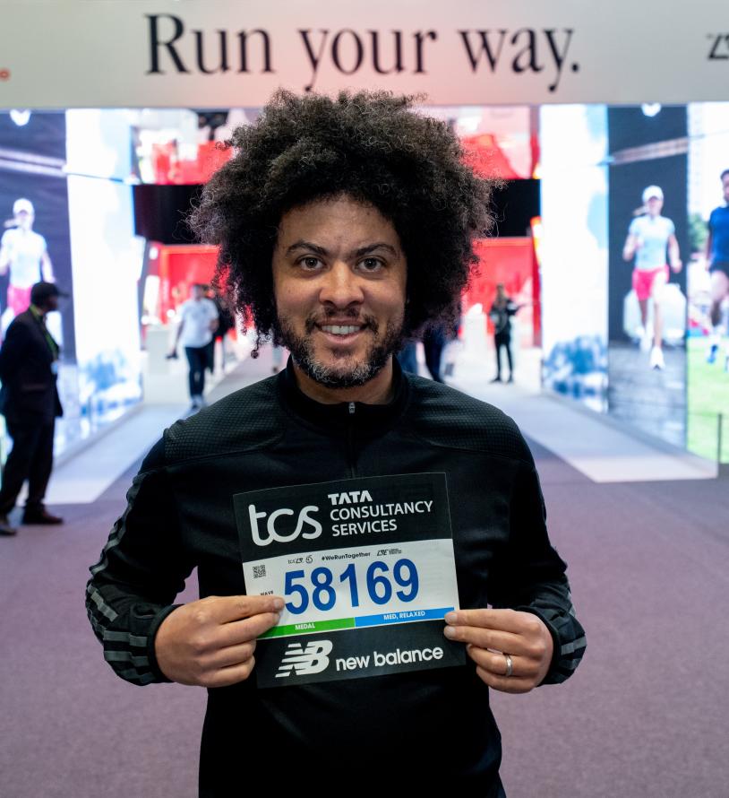 A runner collecting their number at the TCS London Marathon Running Show