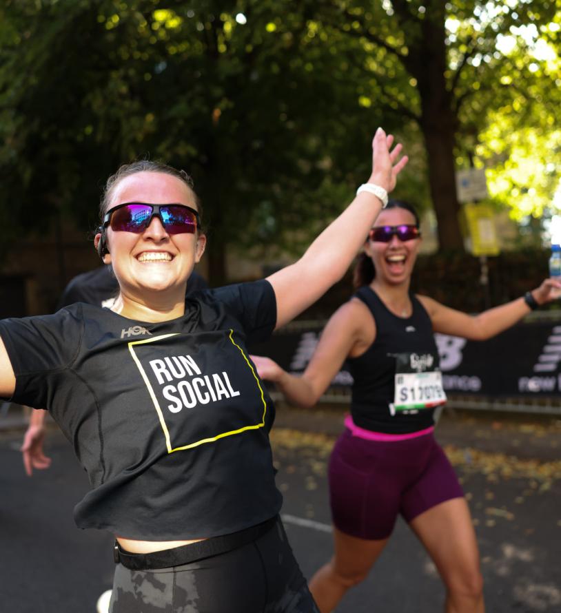 Runners throw their hands in the air in celebration 